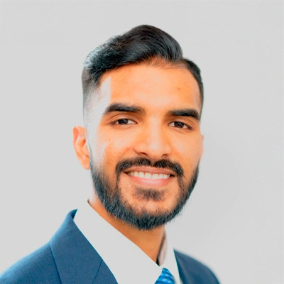 Dr. Cardin Chellan in a suit and tie against a light background